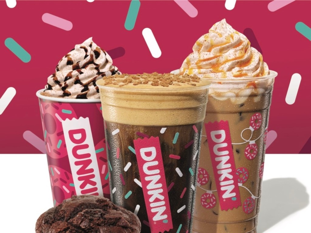 Dunkin holiday drinks against pink background with confetti