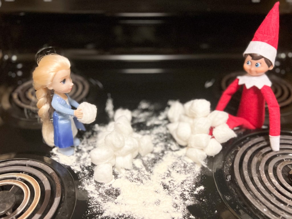 elf and elsa having snowball fight with cotton balls