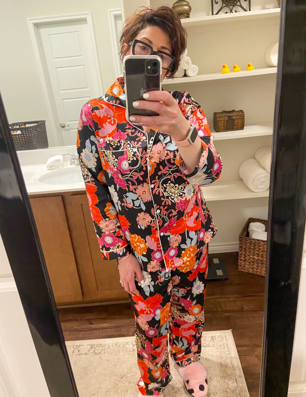 woman taking selfie in mirror wearing printed pajamas