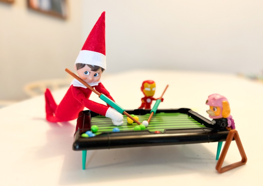 elf and toys playing billiards