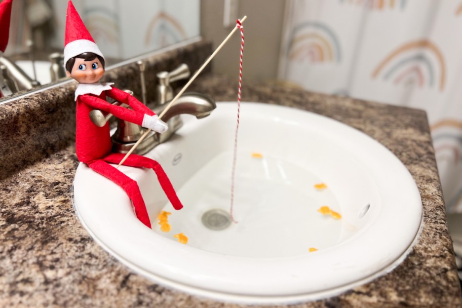 elf on the shelf fishing in sink, one of our dollar tree elf on a shelf ideas