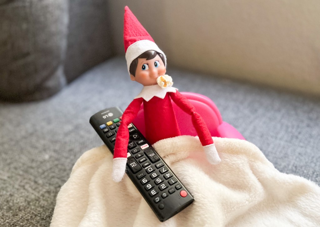 elf holding remote eating popcorn