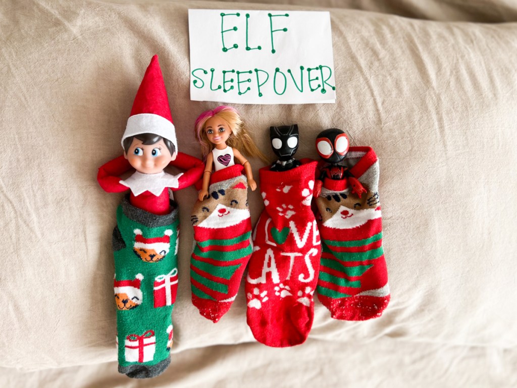 elf and dolls laying in socks