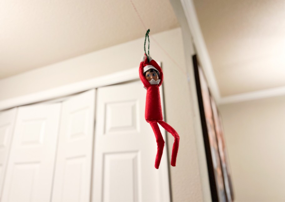 elf hanging on ceiling from string, one of our dollar tree elf on a shelf ideas