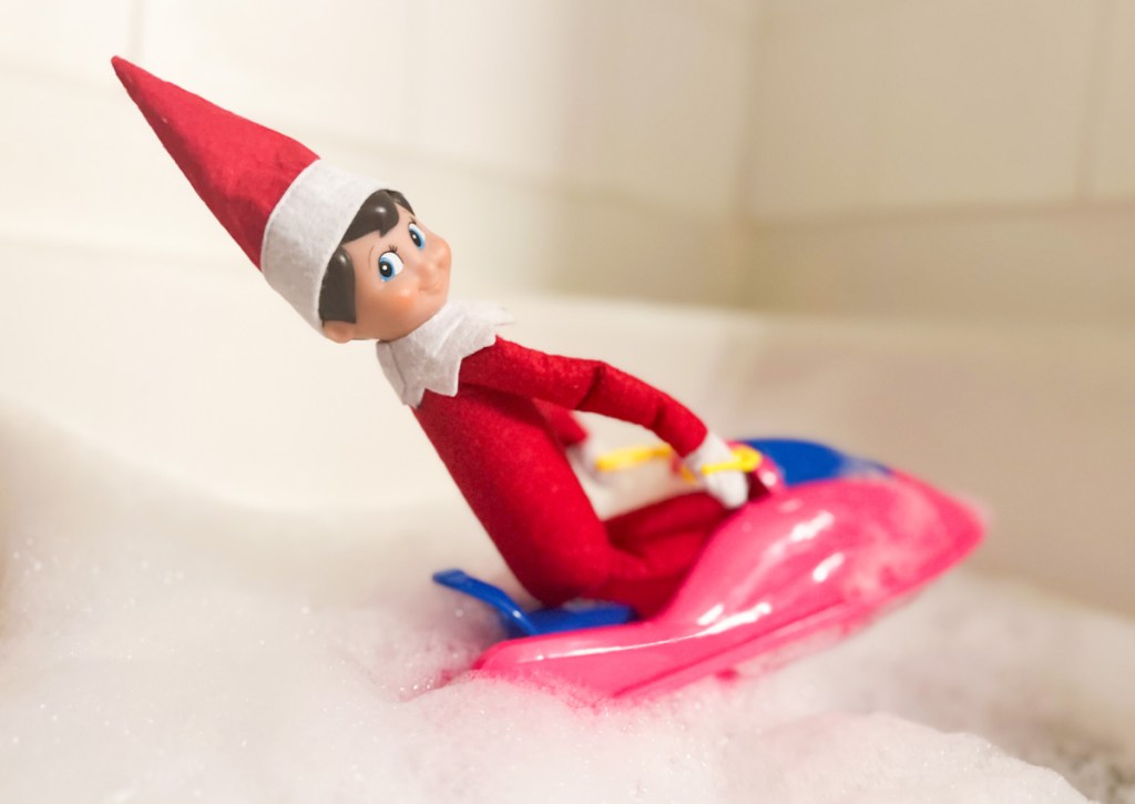 elf on a toy doll jet ski