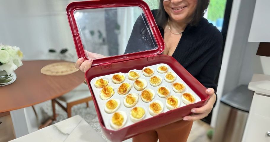 woman holding fancy panz with deviled egg insert