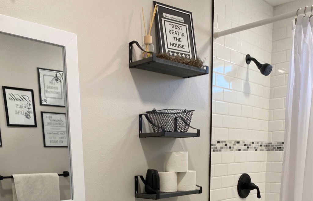 floating shelves with decor and toilet paper in the bathroom