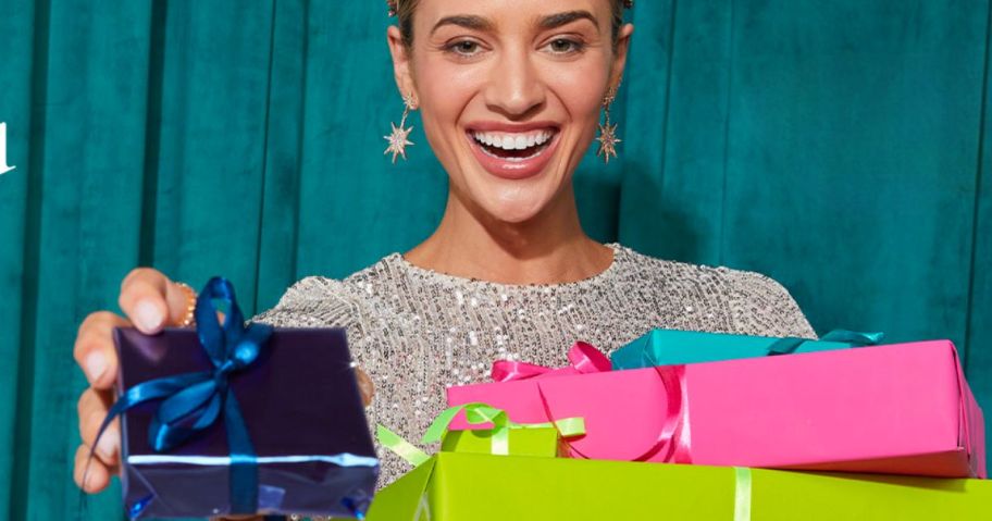 a woman holding brightly wrapped gifts