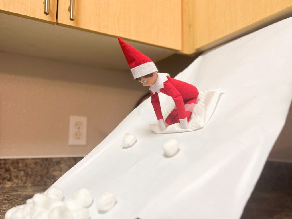 elf going down wrapping paper ramp