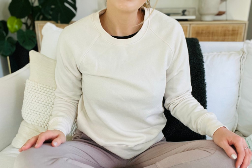 woman in cream crewneck sweatshirt