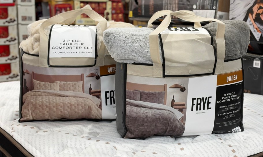 2 frye comforter sets on a mattress in a costco store