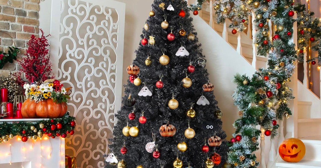 black christmas tree decorated with pumpkins and christmas ornaments