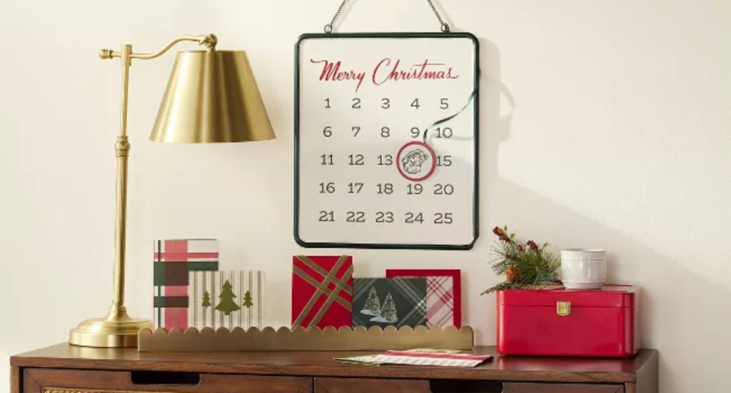 table with gold lamp holiday cards and christmas advent calendar countdown