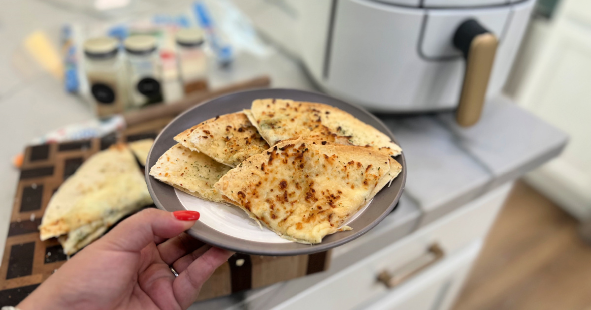 holdlng a plate with garlic tortilla