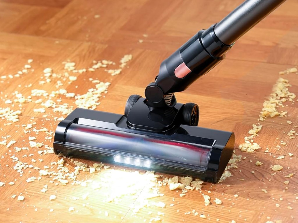 cordless vac cleaning up mess on hardwood floor