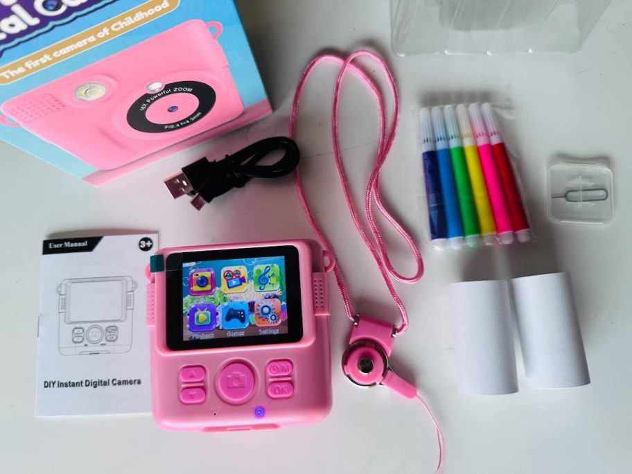 pink kids camera and accessories on counter