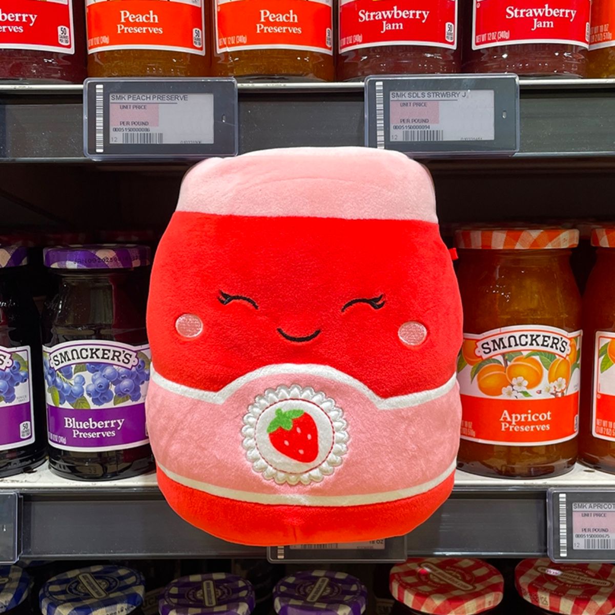 Squishmallow plush that looks like a jar of jam in a jam aisle