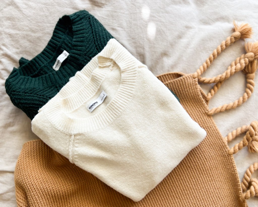 white and green sweaters in a pile