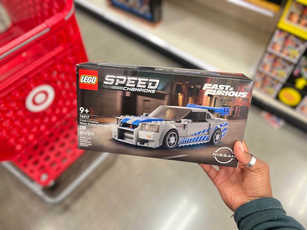 holding a Fast & Furious LEGO set