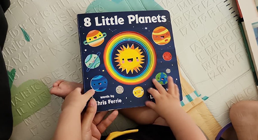 little boy reading 8 little planets book