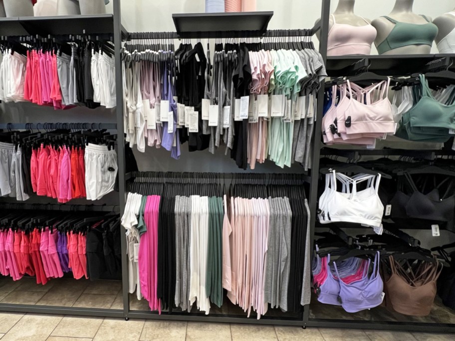 display wall of tops, shorts, and spots bras in lululemon store