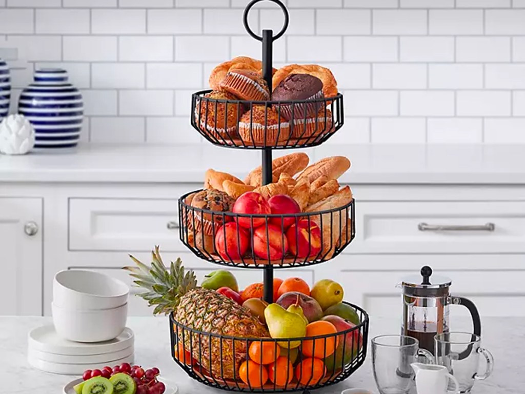 3 ticket basket full of fruits and muffins on countertop