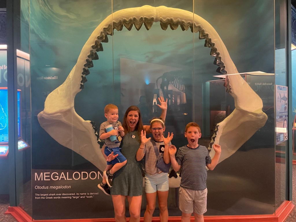 family in front of shark jaw bone
