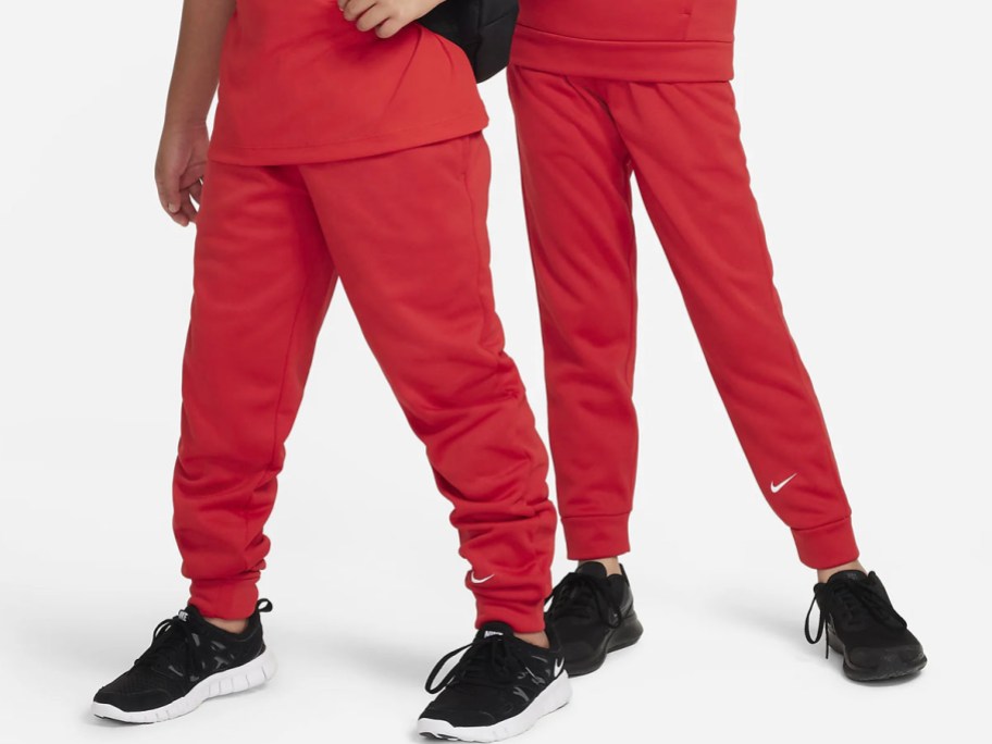 boy and girl wearing red nike pants