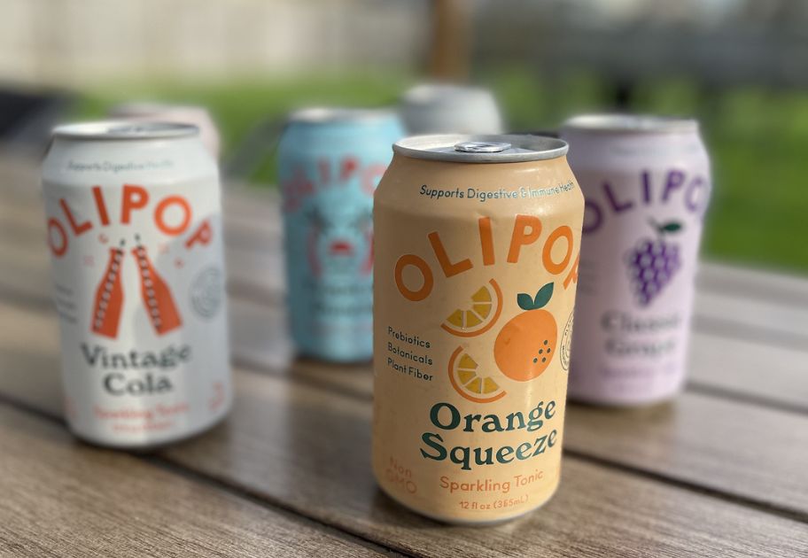 various cans of different flavors of Olipop Soda