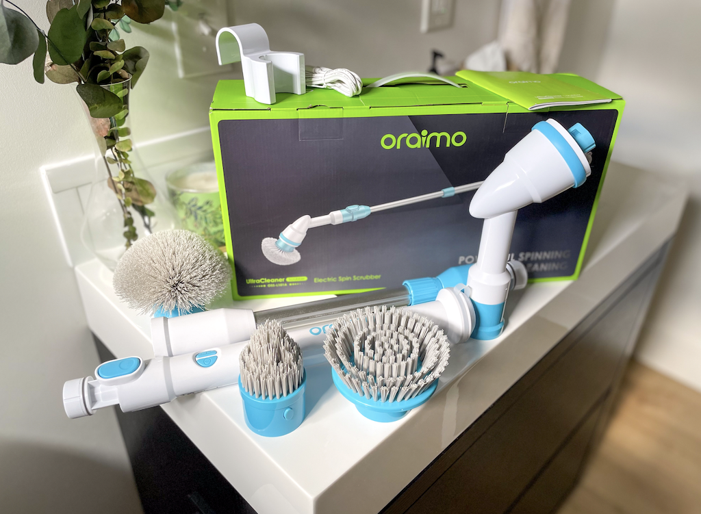 Oraimo Electric Spin Scrubber box with brush and heads around it