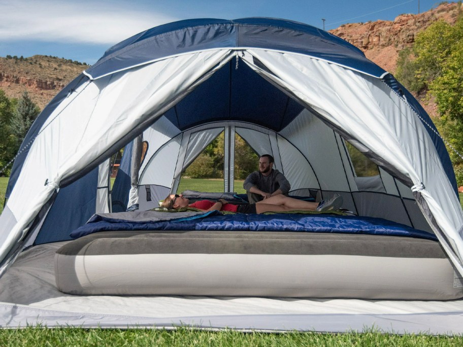 blue and gray tent with person sitting inside