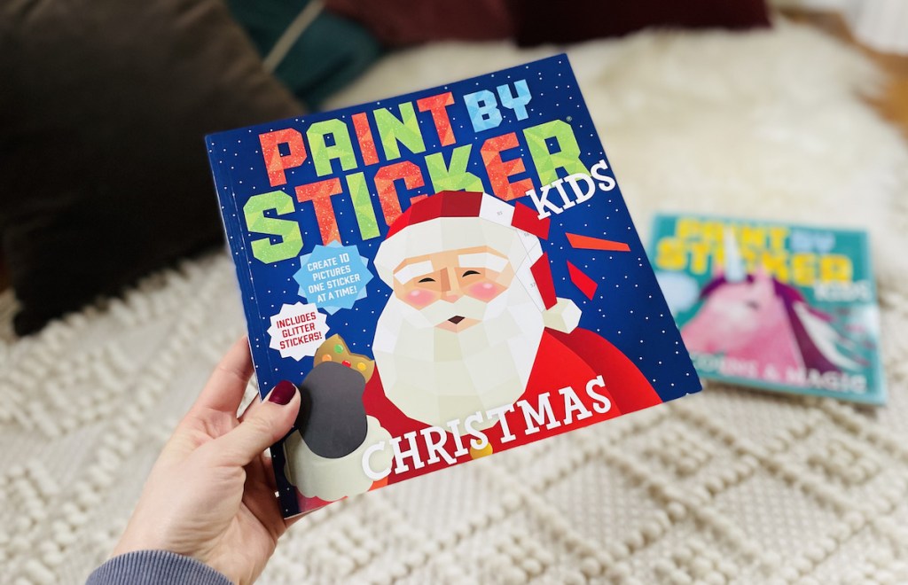 hand holding a paint by sticker santa book