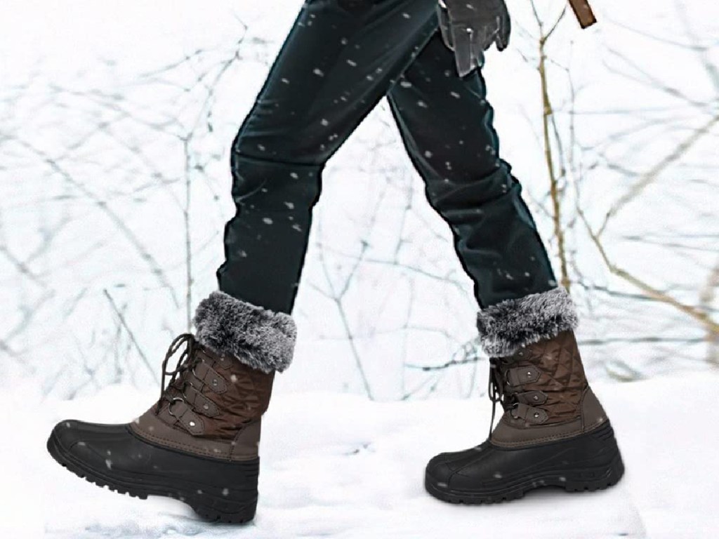 person walking with brown snow boots that have fur at the top