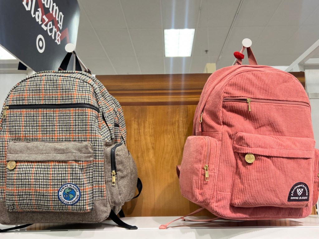 plaid and pink backpacks displayed on shelves