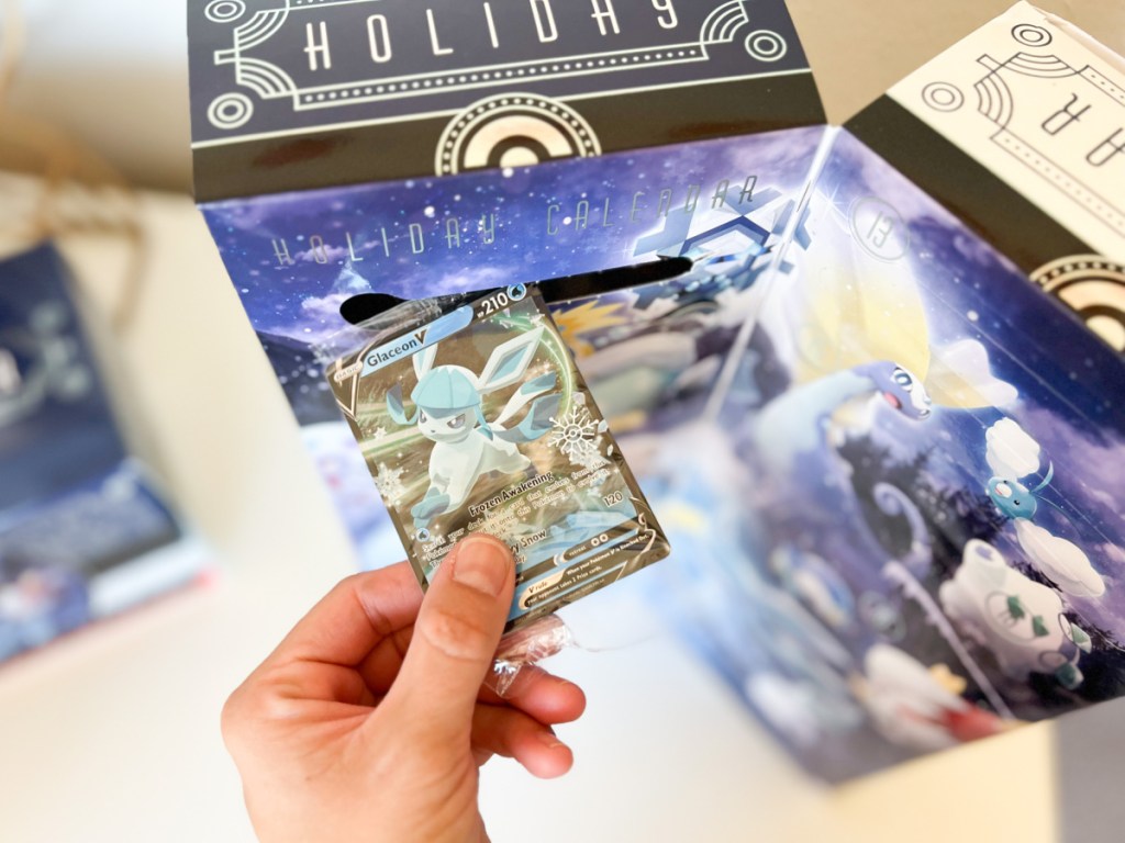 hand grabbing pokemon card out of advent calendar
