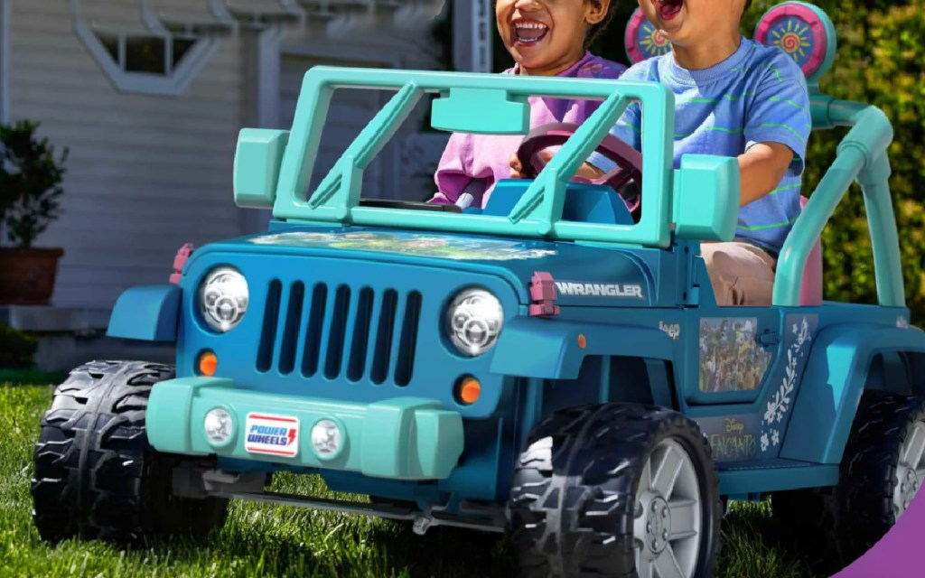 two kids riding on power wheels encanto jeep