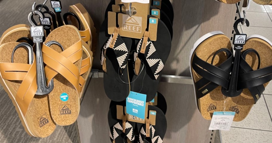 tan and black reef sandals hanging in kohls store 