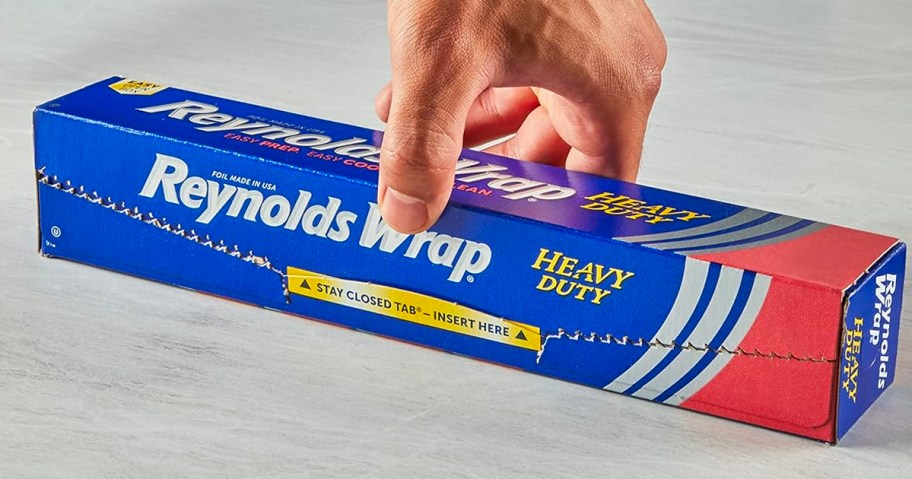 hand picking up reynolds wrap