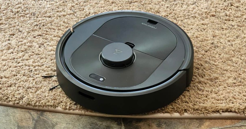 black robo vacuum going over carpet