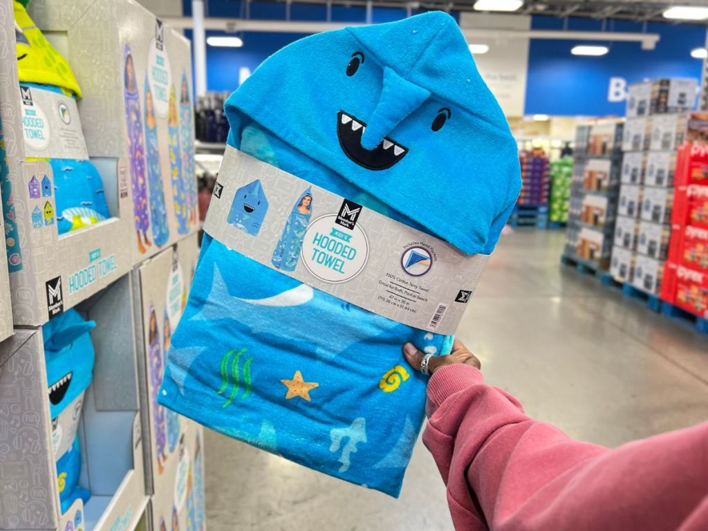 hand holding a Shark Kid's Hooded towel in store at Sam's Club