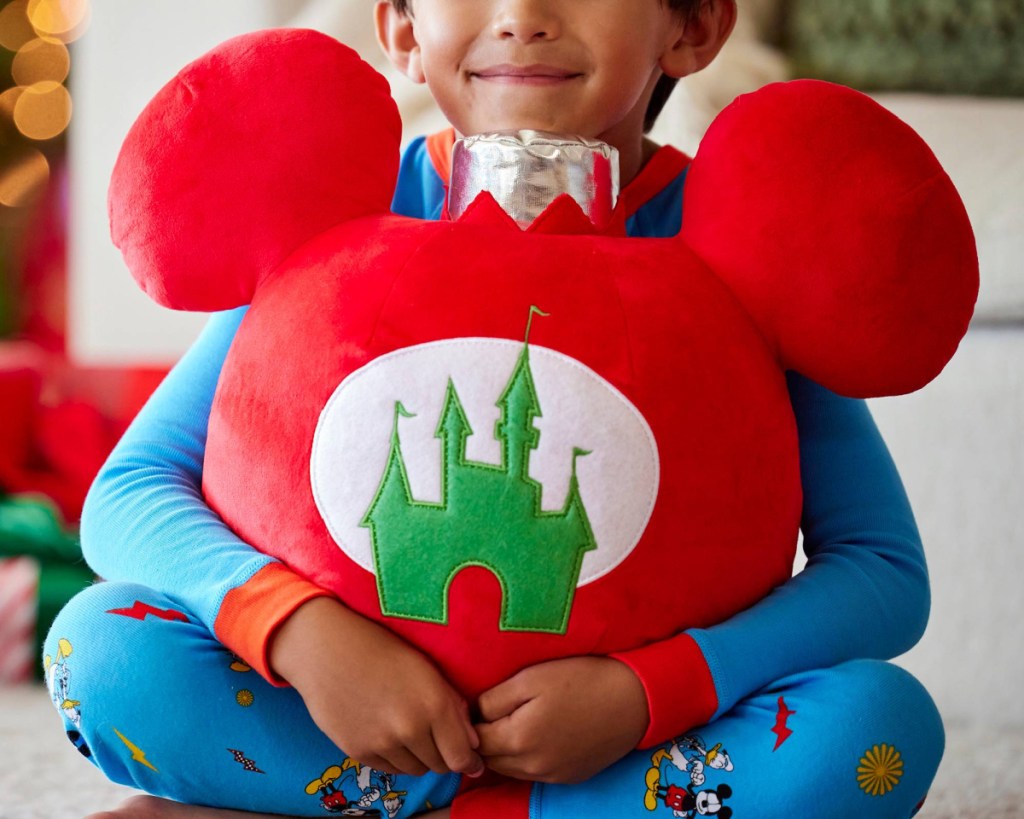 boy holding mickey ornament pillow