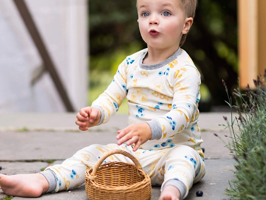 toddler wearing snack time pajamas with a bakset