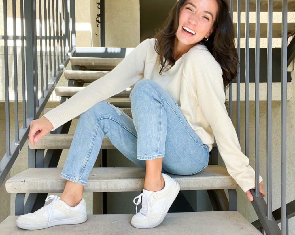 woman sitting on stairs in sweater
