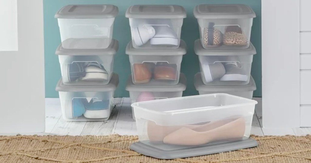 clear storage boxes full of items with gray lids in closet