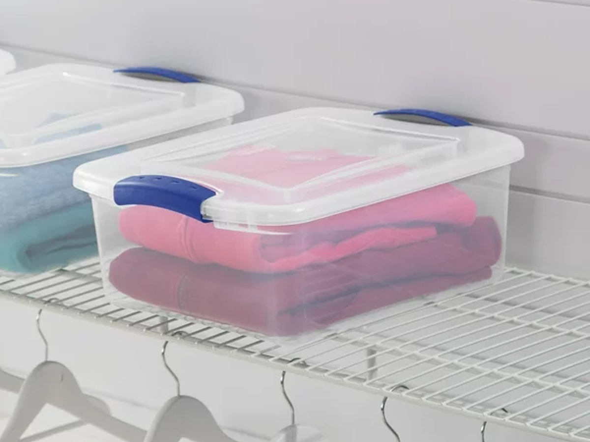 sterlite plastic storage box with clothes folded inside on shelf in closet