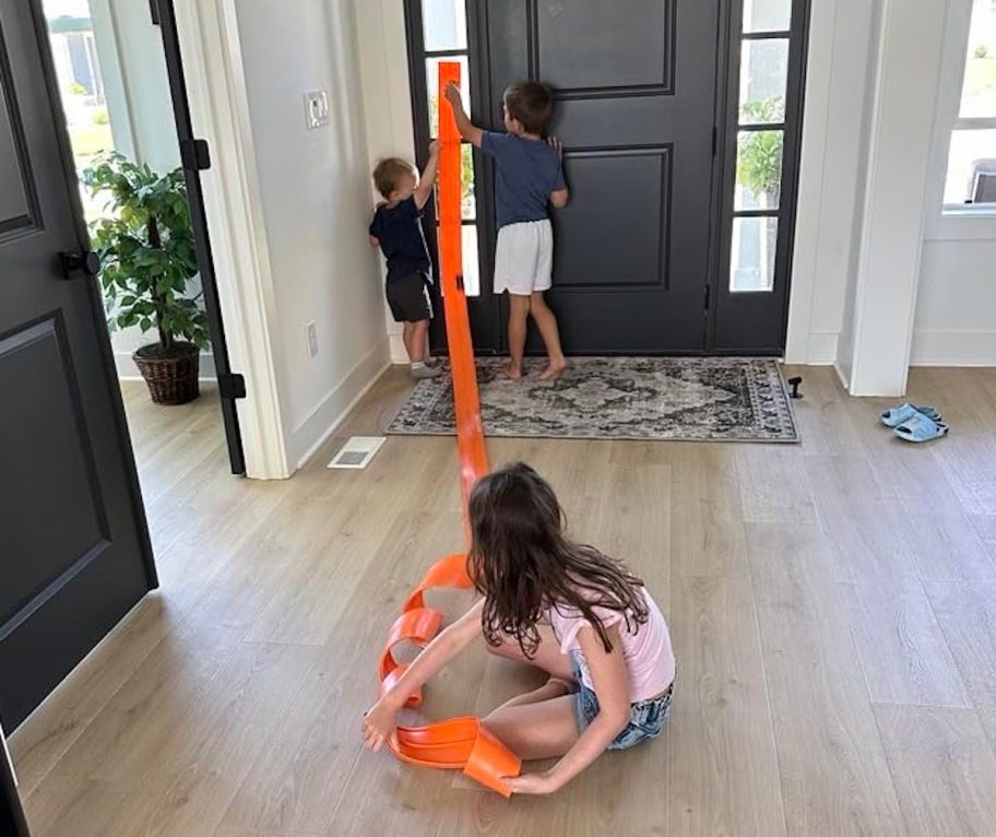 kids playing with orange suction cup race track