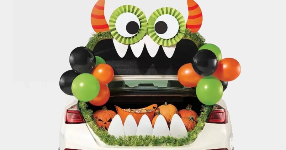 green and orange monster trunk or treat decor on car