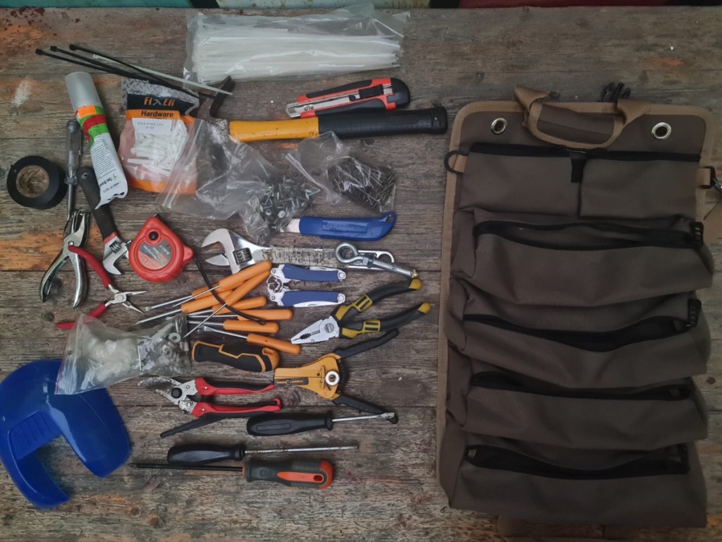 tools next to a tool roll bag