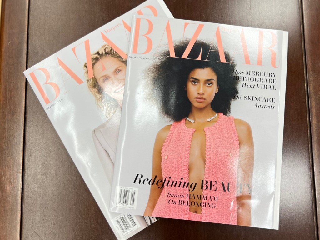 two bazaar magazines displayed on the couch