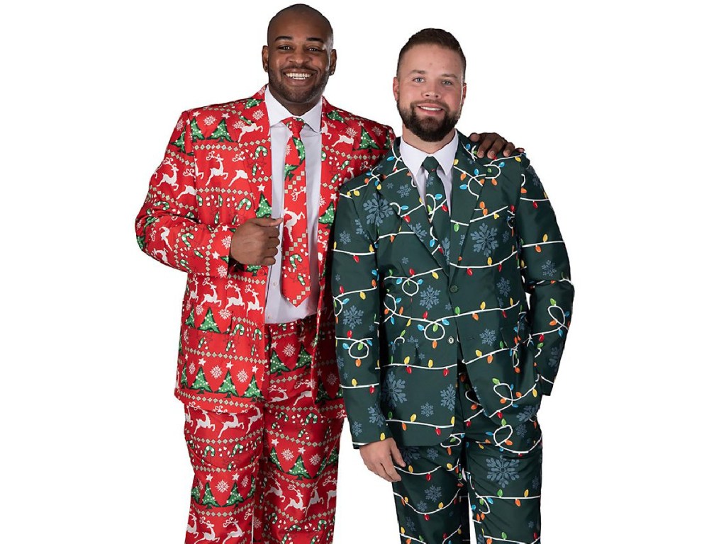 two men wearing Christmas suits standing together